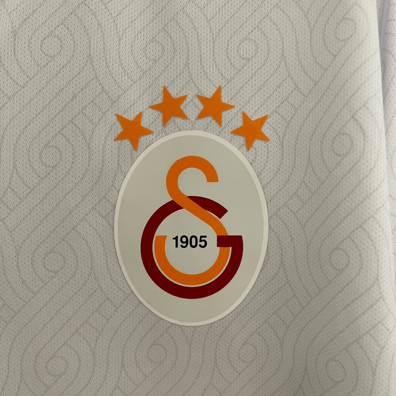 Camisa Galatasary II Away 2024-2025 Versão Torcedor Branca, Vermelho, Preto, Mosaico Sixt Gola V Vermelho e Laranja