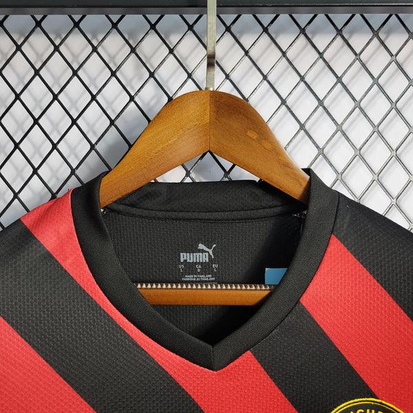 camisa-manchester-city-away-22-23-vermelho-preto-amarelo-gola-v