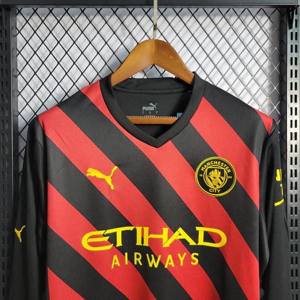 camisa-manchester-city-away-22-23-vermelho-preto-amarelo-gola-v