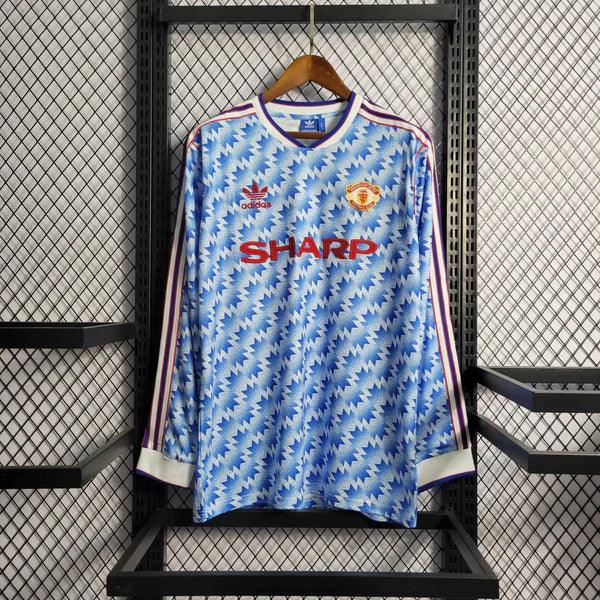 camisa-manchester-united-manga-longa-retrô-away-1990-1992-azul-listras-branca-punho-eslastico-gola-v-bordado-fundo-grade