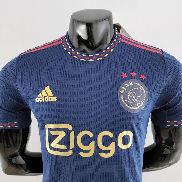 camisa-ajax-manto-ajax-away-ii-azul-amarelo-vermelho-adidas-22-23-torcedor-jogador-campeonato-alemao-ajax-Brian-Brobbey